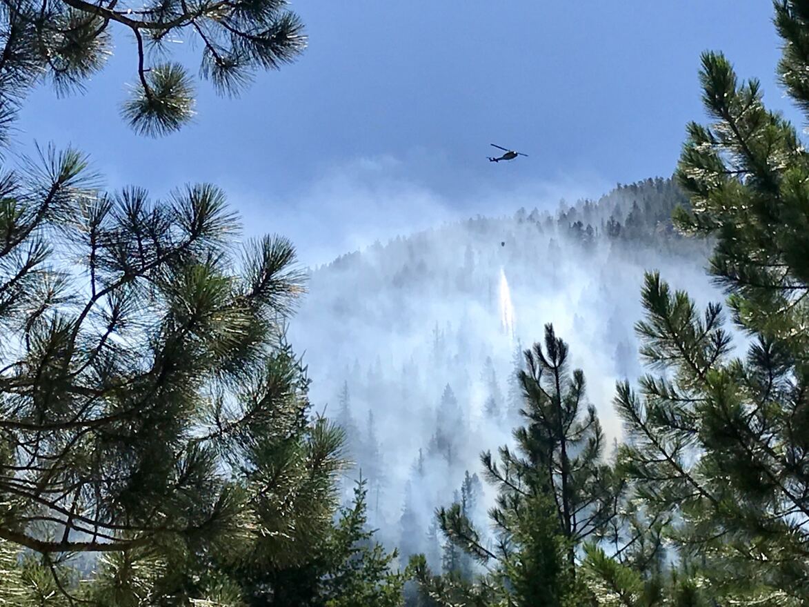 A helicopter drops water on the Beeskove fire north of Missoula July 26, 2019.